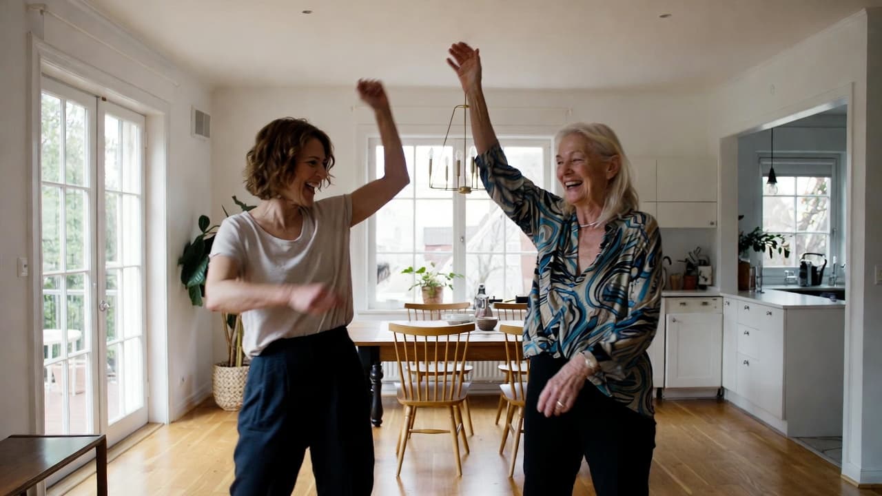 Elderly woman and younger woman dancing joyfully together in a bright modern Scandinavian-style living room.